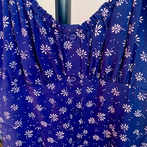 Blue pattern dress with puffy short sleeves.